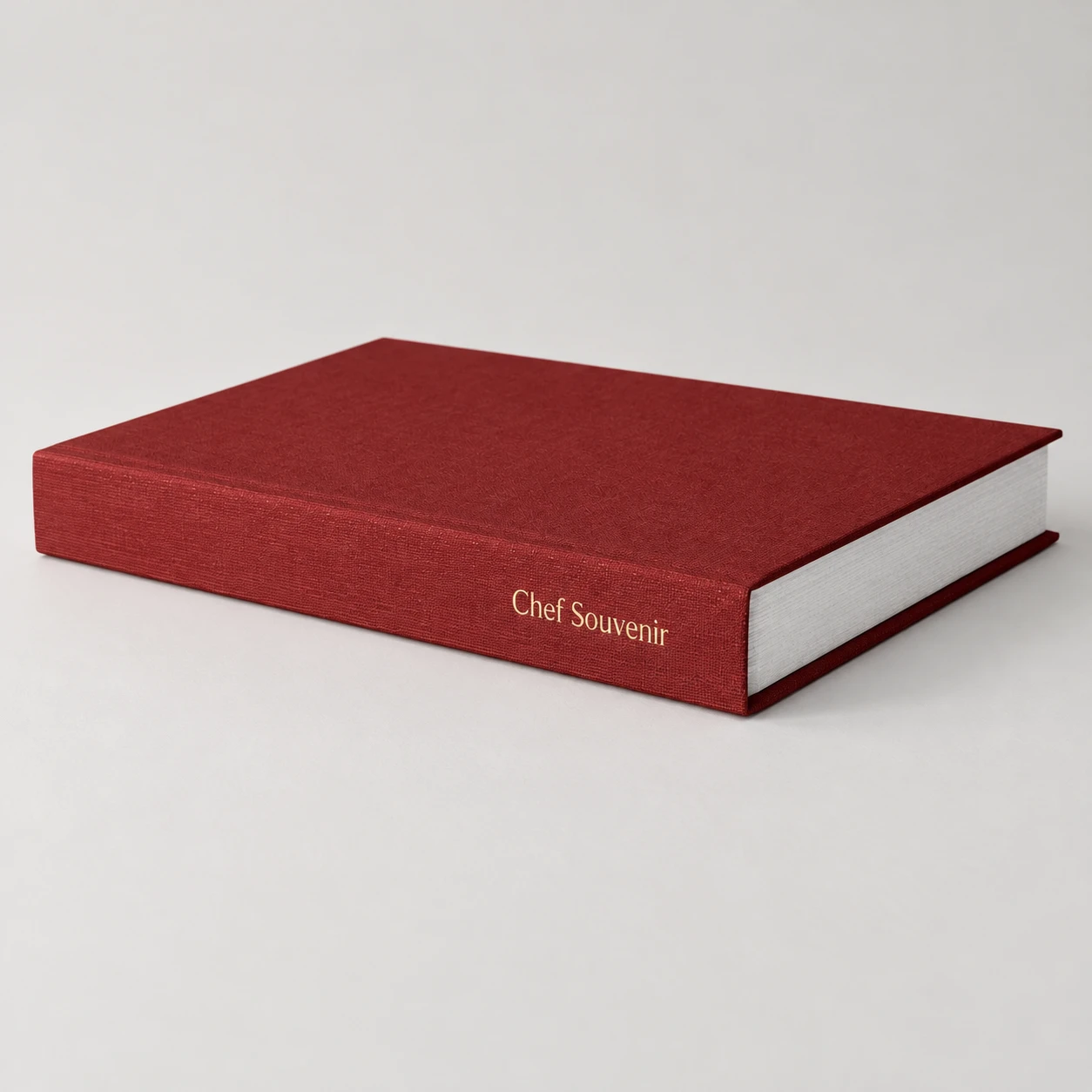 Red linen hardcover recipe book with a gold-stamped spine